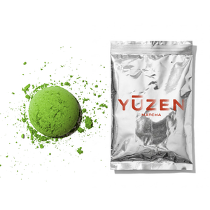 Nami ceremonial matcha sample in a silver foil sachet beside a disc of bright green powder