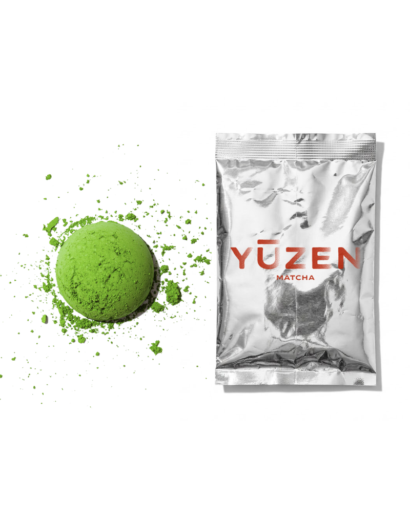Nami ceremonial matcha sample in a silver foil sachet beside a disc of bright green powder