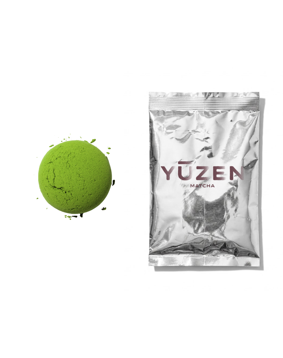 Sakura ceremonial matcha sample in a silver foil sachet beside a pressed disc of powder