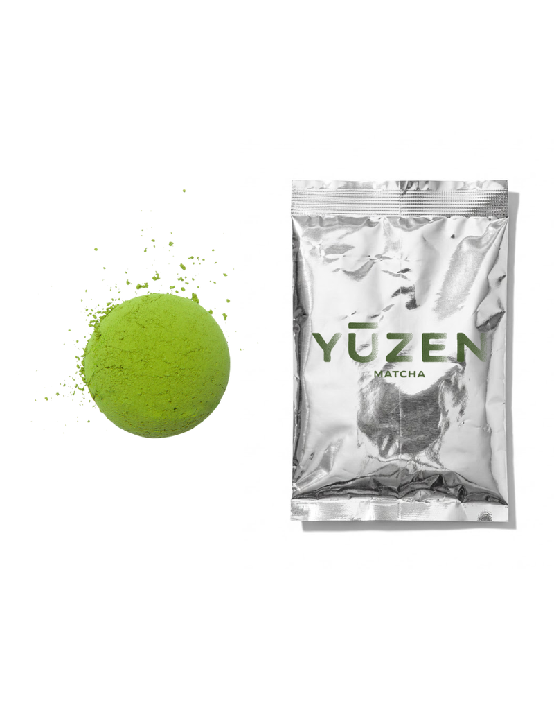 Tsubasa café-grade matcha sample in a silver foil sachet beside a disc of green powder